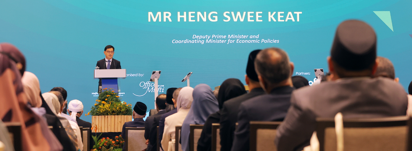 Mr. Heng Swee Keat speaking at a podium facing audience at an event.